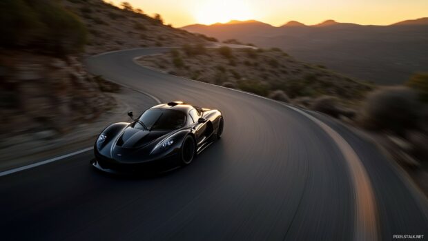 A sleek black sports car speeding down a winding mountain road at sunset.