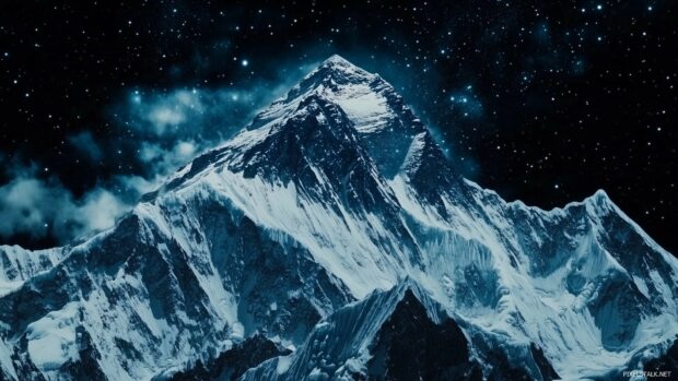 A snow covered Mountain ridge glowing under the stars.