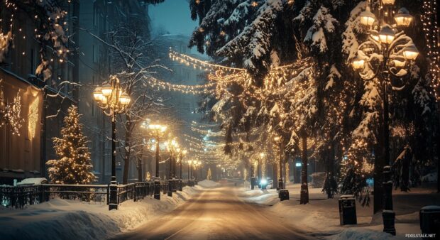 A snow covered street with vintage style Christmas lights.