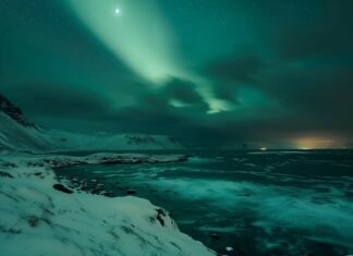 A stunning aurora borealis lighting up the night sky over a snowy landscape.