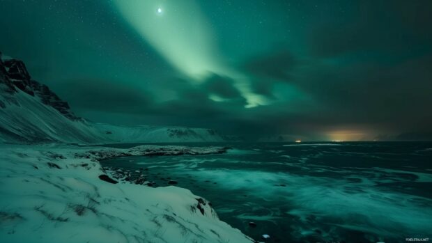 A stunning aurora borealis lighting up the night sky over a snowy landscape.