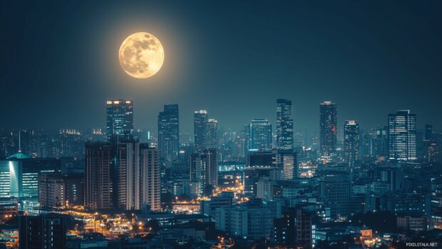 A stunning cityscape at night 1920x1080 Wallpaper with a brilliant full moon hanging over a bustling skyline, casting a gentle light on the city streets and buildings.