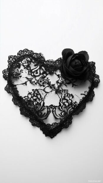 A textured black heart with intricate lace patterns.