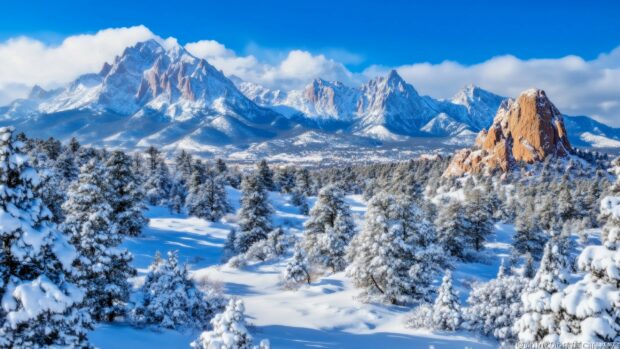 A winter scene in the Rocky Mountains, with snow covered rocks and sharp peaks.