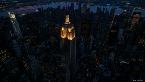 Aerial view of New York City skyline at dusk, with the Empire State Building in the center.