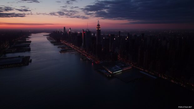 Aerial view of New York City skyline at dusk, with the Empire State Building in the center.