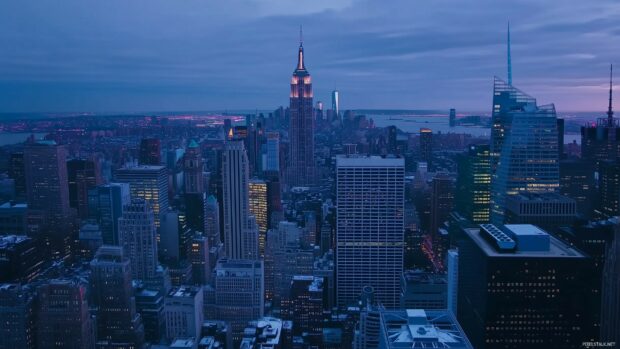 Aerial view of New York City skyline at dusk, with the Empire State Building in the center.