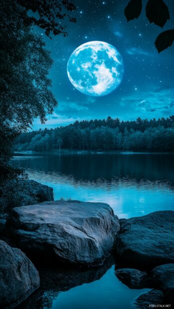 Aesthetic Moon Wallpaper with a Blue Moon casting its soft, blue light over a picturesque night sky filled with shimmering stars.