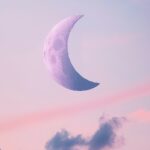 Aesthetic Moon Wallpaper with a delicate crescent moon in a soft, pastel sky.