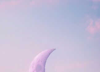 Aesthetic Moon Wallpaper with a delicate crescent moon in a soft, pastel sky.