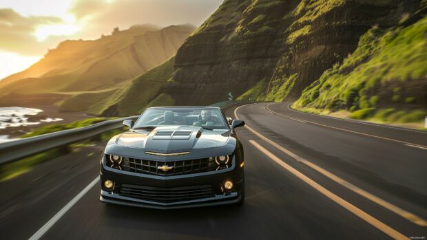 Car Live Wallpaper 4K with a Camaro convertible cruising through a scenic mountain pass during sunset.