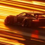 Car PC Wallpaper with a GT3 race car zooming down a straightaway at sunrise.