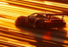 Car PC Wallpaper with a GT3 race car zooming down a straightaway at sunrise.