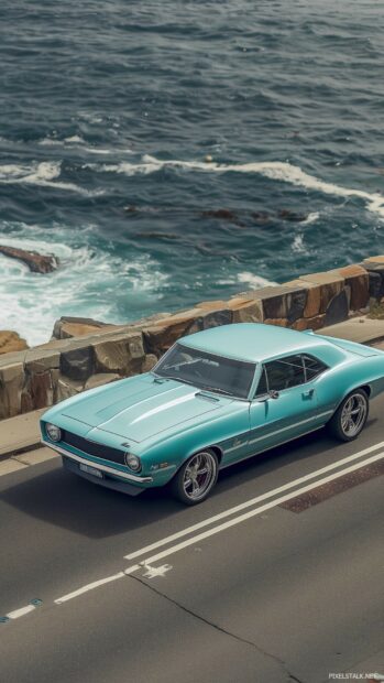 Car iPhone wallpaper with a car driving along a coastal highway with ocean views.