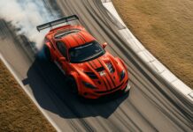 Cars Wallpaper 4K with A bright red race car drifting through a sharp corner on a track, with smoke billowing from the tires.