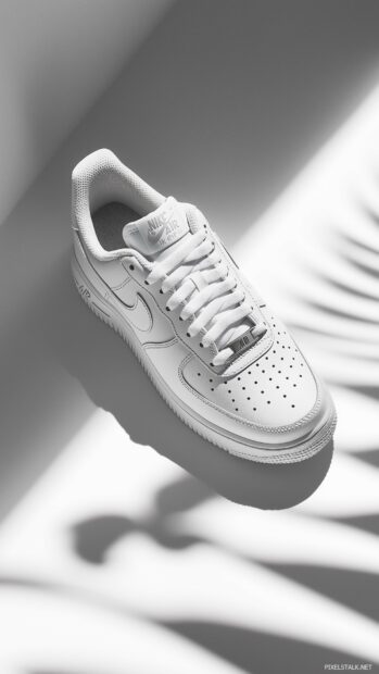 Classic Nike Air Force 1 shoes displayed on a minimalistic white background.