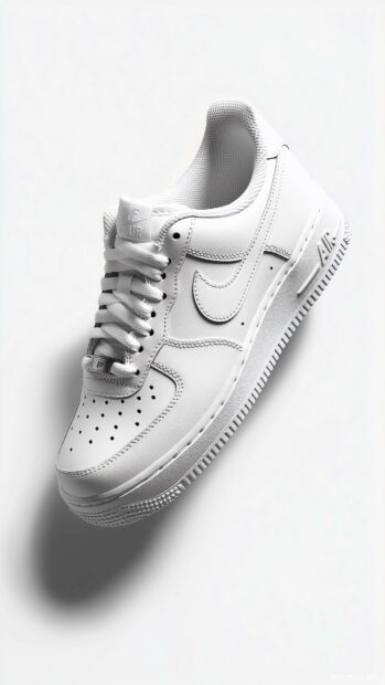 Classic Nike Air Force 1 shoes displayed on a minimalistic white background with subtle shadowing (2).