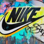 Classic Nike logo 4K on a bright, colorful graffiti wall background, with bold textures and street art detailing.