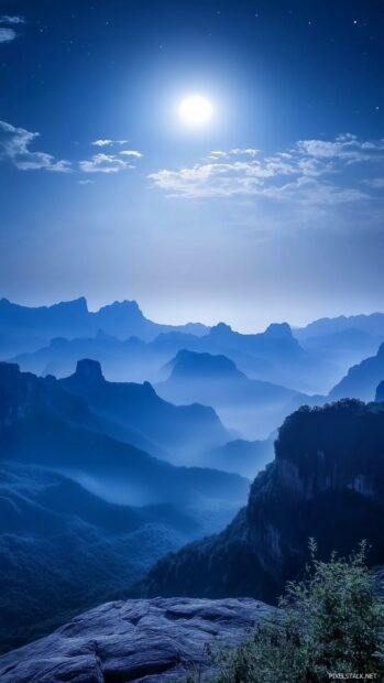 Elegant moonlight illuminating a simple mountain range, with soft gradient shading in the sky.