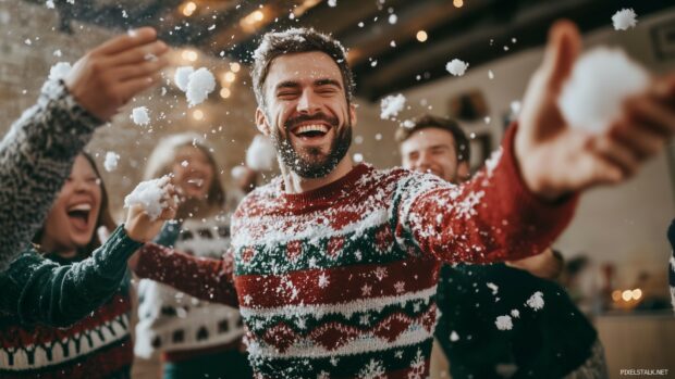 Funny Christmas Wallpaper with a funny Christmas party scene where a group of friends in silly holiday sweaters are having a snowball fight indoors, with snow flying and laughter filling the room.