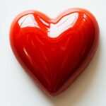 Heart shape in bright red on a simple white background.