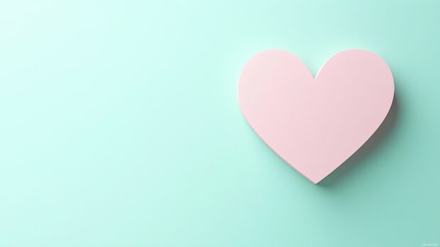 Heart silhouette in soft pink on a matte pastel green background.