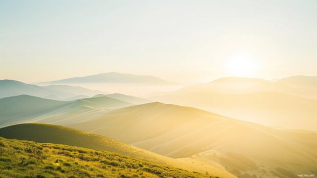 Laptop HD Wallpaper with a serene mountain landscape at sunrise with a clear sky .