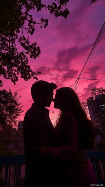 Love Wallpaper HD with a silhouette of a couple embracing under a pink and purple sky filled with clouds, evoking feelings of deep love and connection.