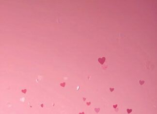 Minimal pink heart confetti over a soft gradient background, creating a cute Valentines theme.