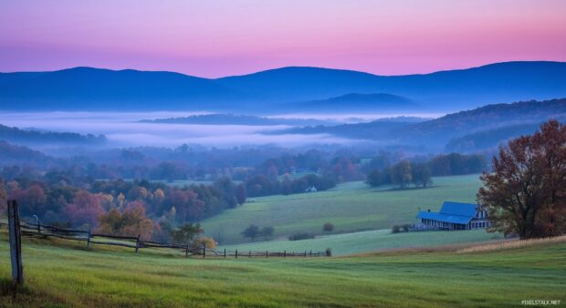 Misty blue Mountains stretching into the horizon under a soft pastel sky.