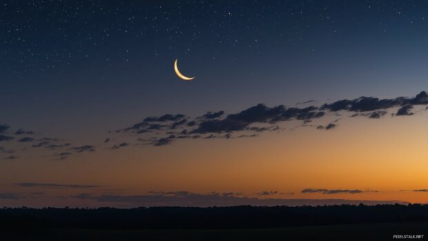 Moon HD Wallpaper with a crescent moon shining brightly amidst a sky full of twinkling stars, casting a soft glow over a peaceful landscape.