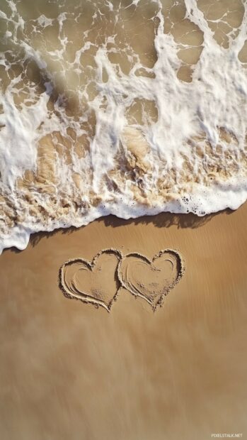 Nature Love Wallpaper with Two intertwined hearts drawn in the sand on a beach, with waves gently approaching, symbolizing everlasting love.