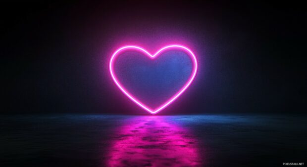 Neon glowing heart in the center of a solid black background.