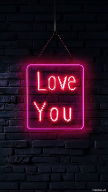 Neon light sign spelling out I Love You in vibrant pink and red, glowing against a dark brick wall for a modern and trendy look.