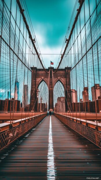 New York City Wallpaper for mobile with the Brooklyn Bridge with faint city lights in the distance, framed by a simple sky.