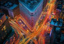 New York Street Wallpaper with the Flatiron Building surrounded by the vibrant energy of the city.