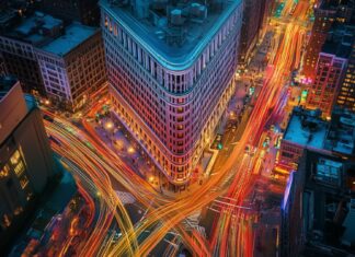 New York Street Wallpaper with the Flatiron Building surrounded by the vibrant energy of the city.