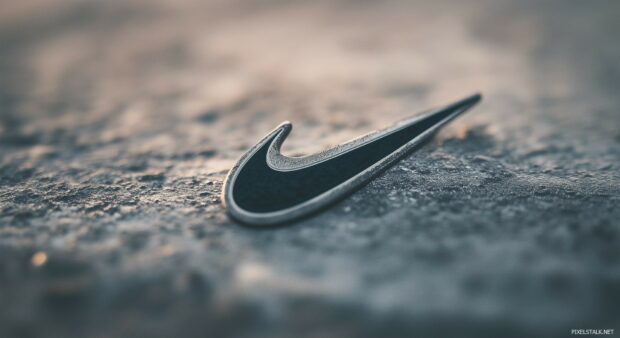 Nike 3D logo in black and white on a distressed concrete background.