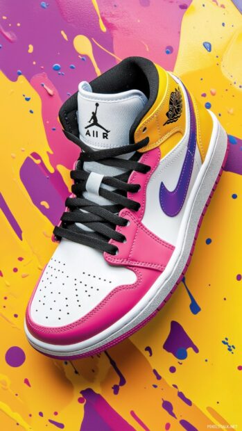 Nike Air Jordan sneakers displayed on a vibrant, abstract color splash background.