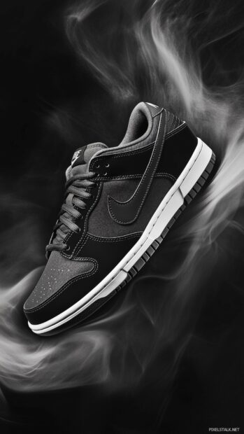 Nike Dunk sneakers in a stylish monochrome color scheme, highlighted on a dark, textured background with soft lighting effects.