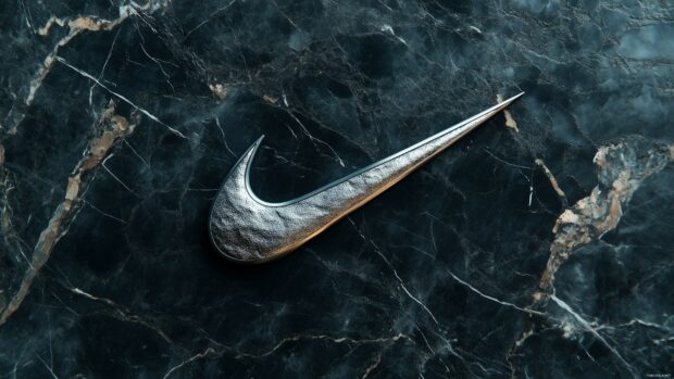 Nike Wallpaper 4K features a swoosh logo in metallic silver against a dark marble texture.