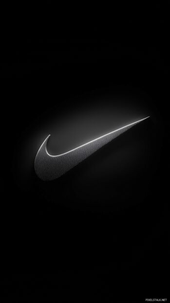 Nike logo illuminated by a soft spotlight effect on a solid black background.