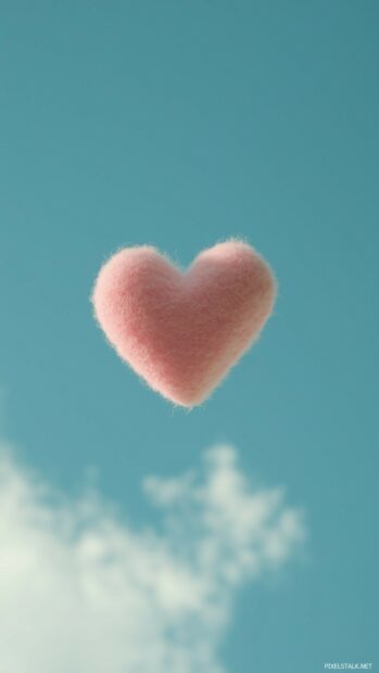 Pastel pink heart floating on a plain sky blue background.