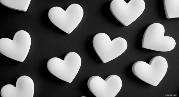 Scattered white heart shapes across a black background.