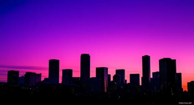 Silhouette of a city skyline at dusk with a soft gradient sky.