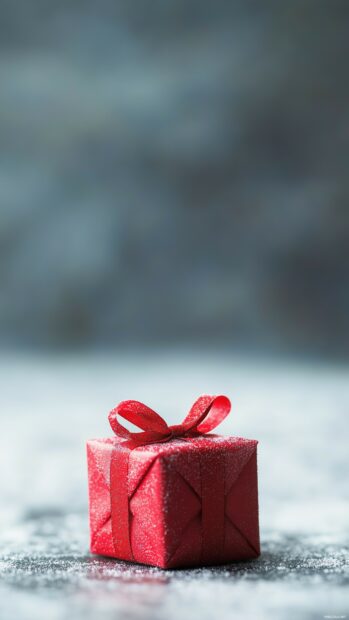 Simple Christmas wallpaper with a soft background with a small, simple Christmas gift wrapped in red, with minimal decorations (2).