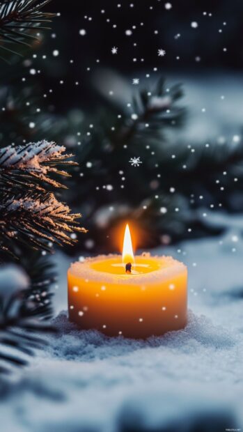 Simple Christmas wallpaper with a soft glowing candle with a gentle flame, surrounded by faint snowflakes.