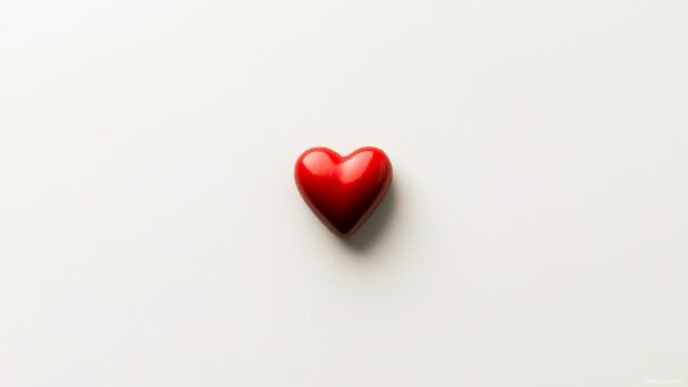 Single red heart in the center of a soft white background.