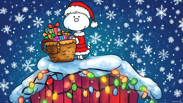 Snoopy dressed as Santa Claus, joyfully holding a sack full of gifts, standing on top of his doghouse.