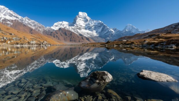 Snow capped mountains desktop 4K wallpaper with a clear blue lake, reflection of the peaks.